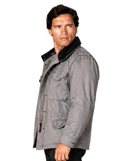 Man wearing a gray jacket with black fur trim on a white background