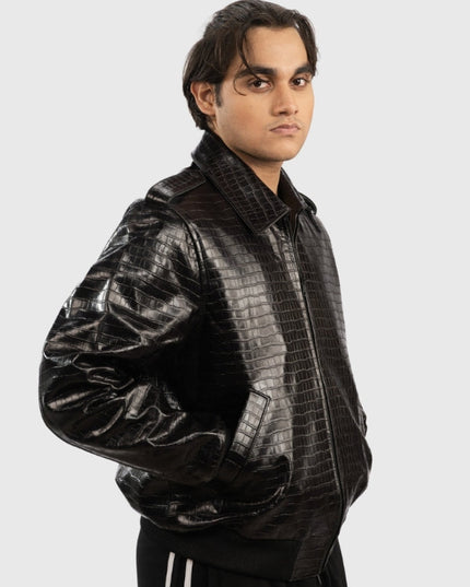 Man wearing a black crocodile-patterned jacket on a white background