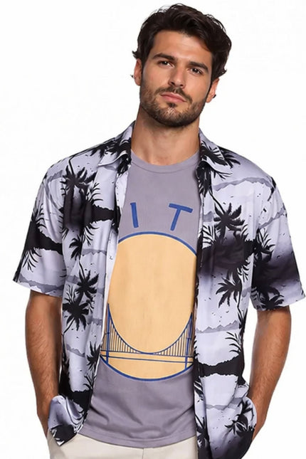 Man wearing a patterned shirt over a graphic t-shirt on a white background