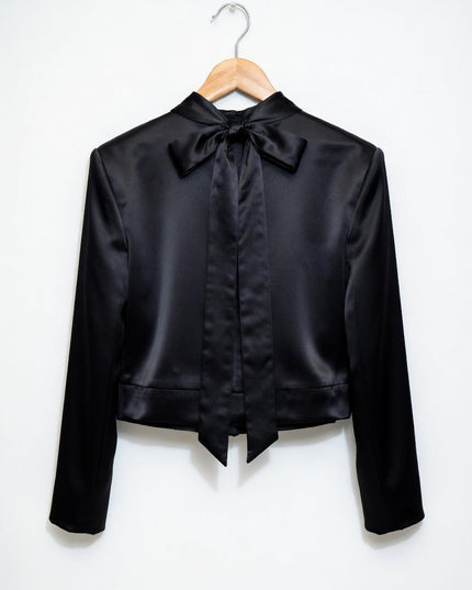 Black satin jacket with a bow on a white background