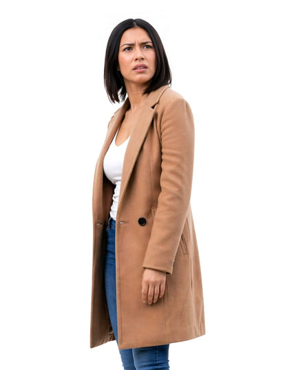 Woman wearing a tan coat on a white background