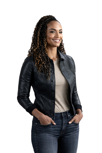 Woman wearing a black leather jacket and jeans on a white background