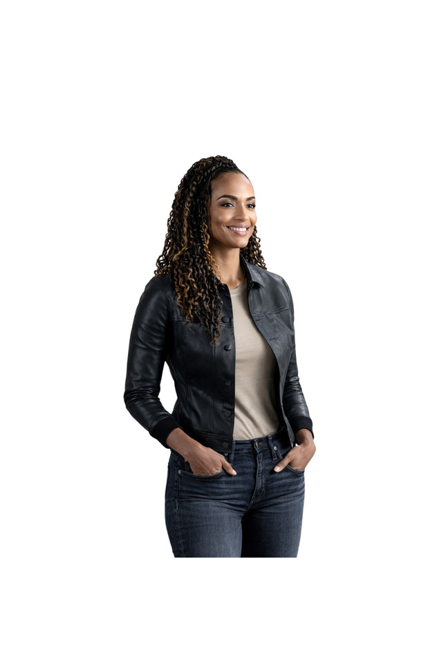 Woman wearing a black leather jacket and jeans on a white background