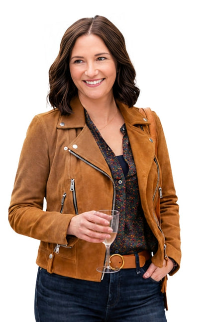 Woman wearing a brown leather jacket holding a glass of wine on a white background