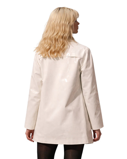 Woman wearing a beige coat on a white background