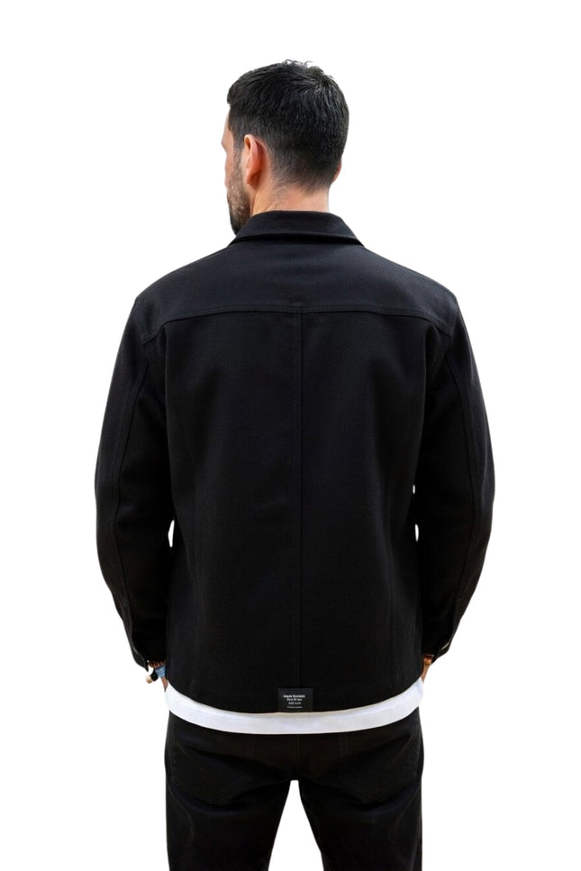 Man wearing a black jacket on a white background
