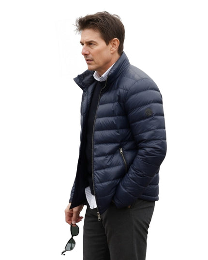 Man wearing a navy blue puffer jacket on a white background