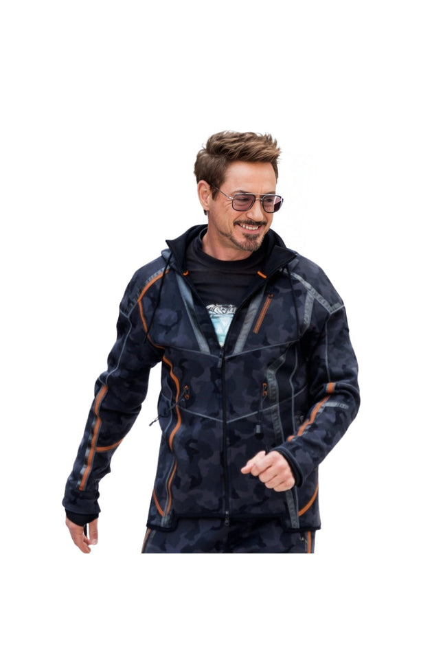Man wearing a dark camouflage jacket with orange accents on a white background