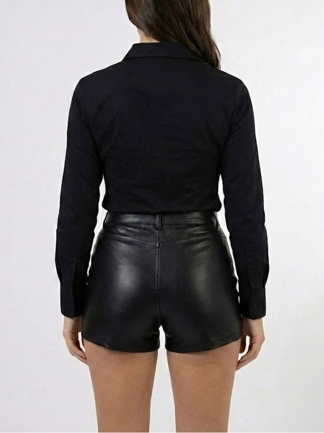 Person wearing a black long-sleeve shirt and black leather shorts on a white background