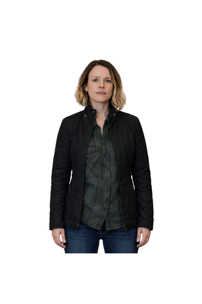 Woman wearing a black jacket over a plaid shirt on a white background