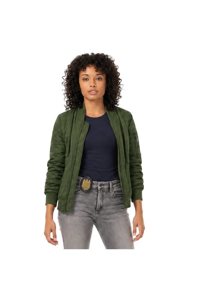 Woman wearing a green jacket, black shirt, and gray jeans on a white background