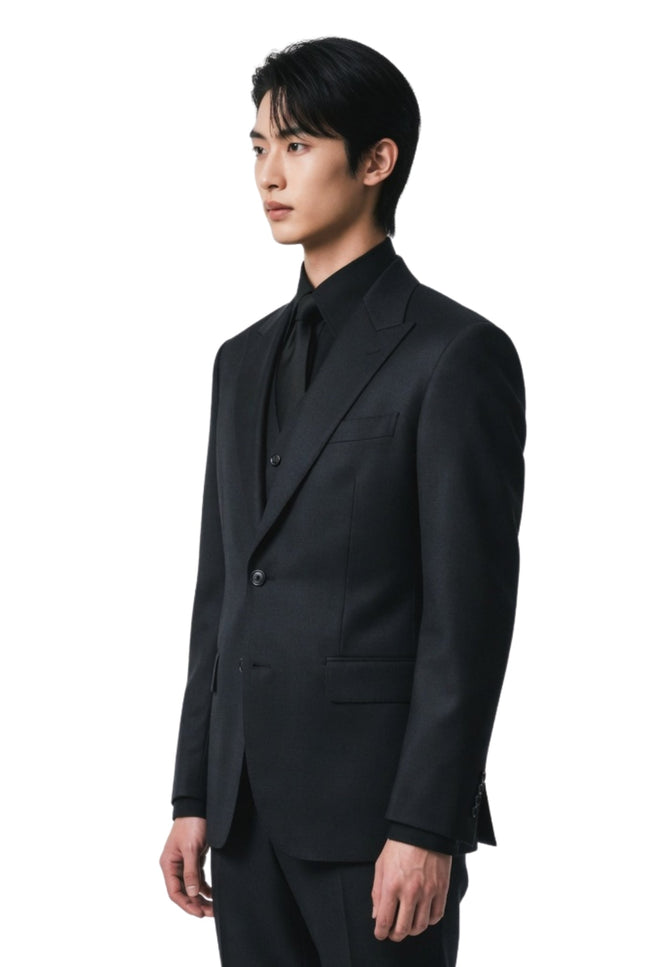 Man wearing a black suit on a white background
