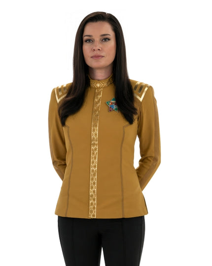 Woman wearing a yellow long-sleeve shirt with decorative elements on a white background