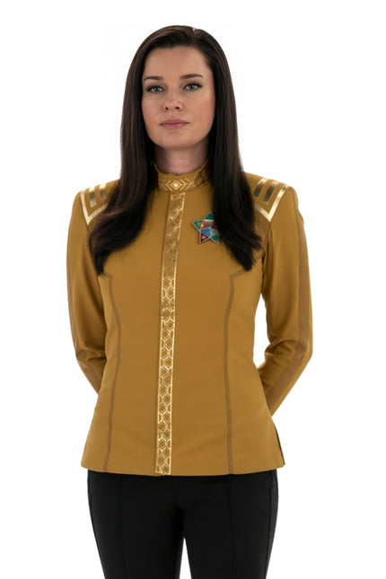 Woman wearing a yellow long-sleeve shirt with decorative elements on a white background