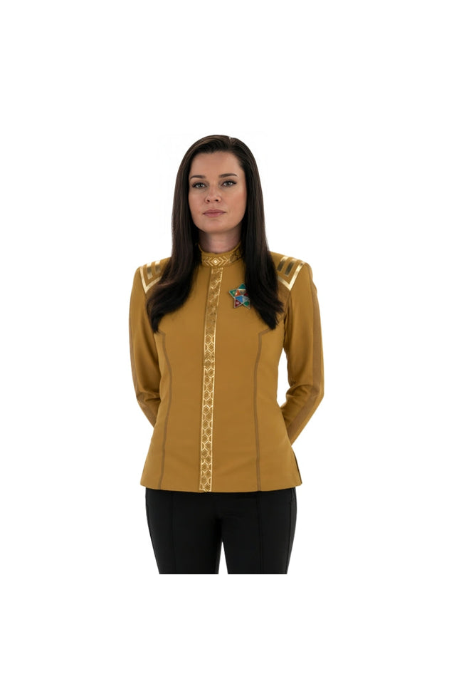 Woman wearing a yellow long-sleeve shirt with decorative elements on a white background