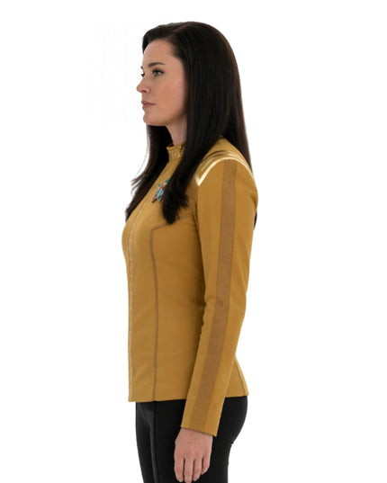 Woman wearing a yellow long-sleeve shirt with a white background