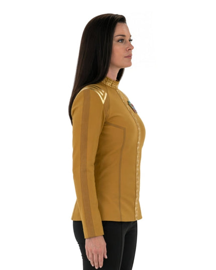 Woman wearing a mustard yellow long-sleeve shirt with a collar on a white background