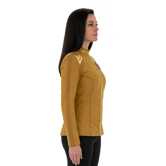 Woman wearing a mustard yellow long-sleeve shirt with a collar on a white background