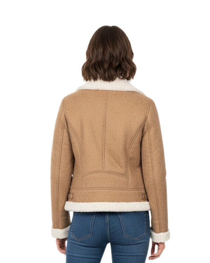 Person wearing a tan jacket with white trim on a white background