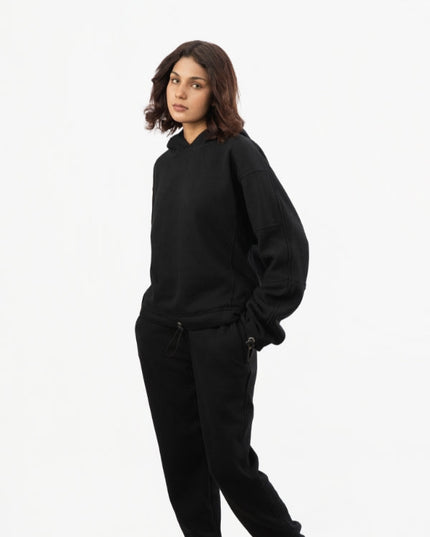 Person wearing a black outfit on a white background