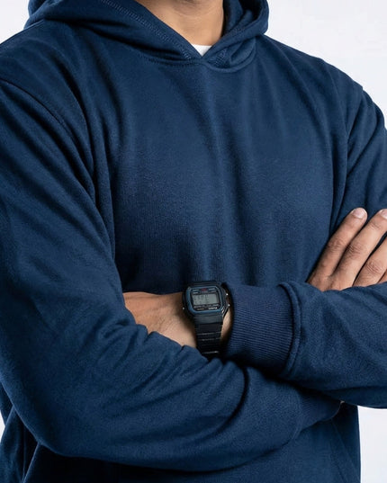 Person wearing a blue hoodie with arms crossed, wearing a black watch on left wrist.