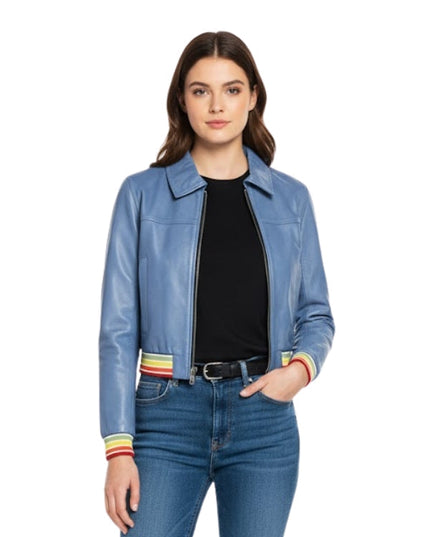 Woman wearing a blue jacket with colorful cuffs and jeans on a white background