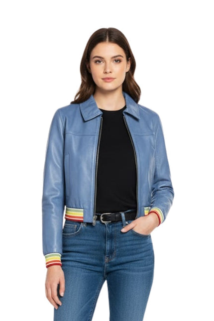 Woman wearing a blue jacket with colorful cuffs and jeans on a white background
