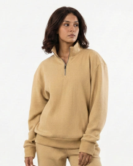 Woman wearing a beige tracksuit on a white background