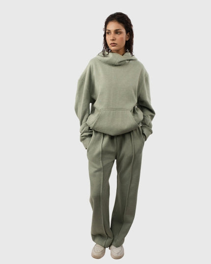 Person wearing a green tracksuit on a white background