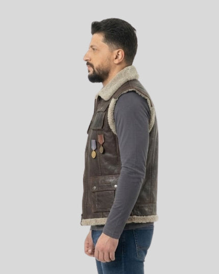 Man wearing a brown leather vest with fur trim on a light gray background