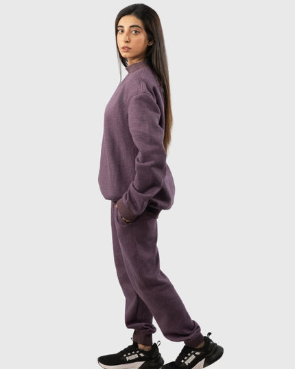 Person wearing a purple tracksuit on a white background