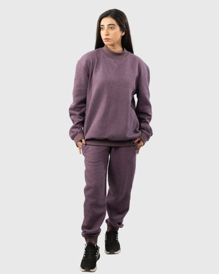 Person wearing a purple sweatshirt and pants set on a white background