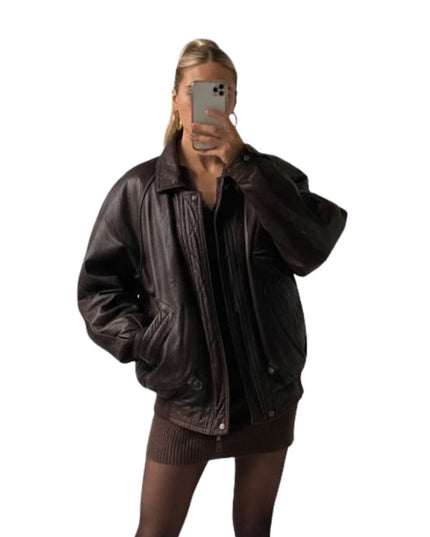 Person wearing a brown leather jacket on a white background