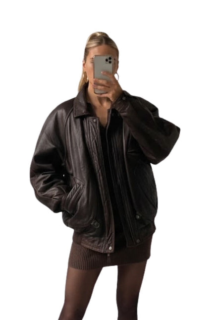 Person wearing a brown leather jacket on a white background