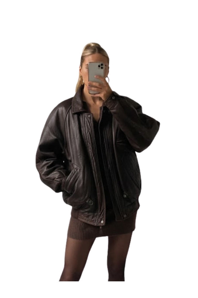 Person wearing a brown leather jacket on a white background