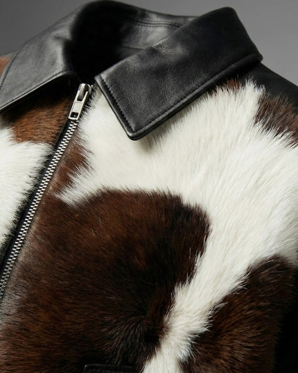 Close-up of a brown and white fur jacket with a black leather collar.