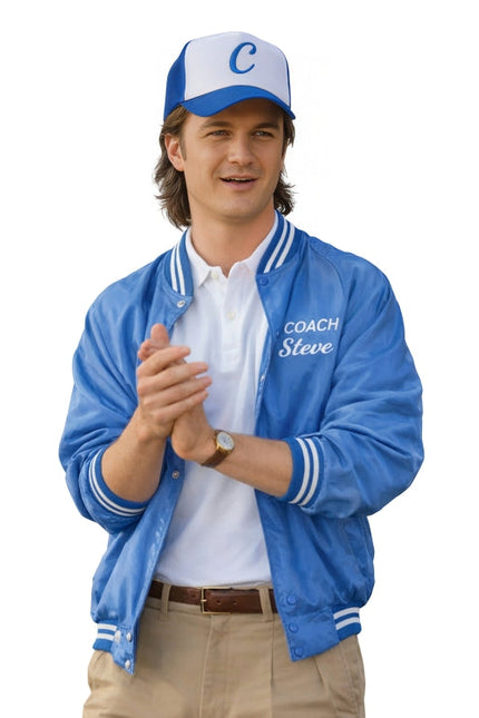 Man wearing a blue jacket with 'Coach Steve' text, white shirt, tan pants, and blue cap on a white background
