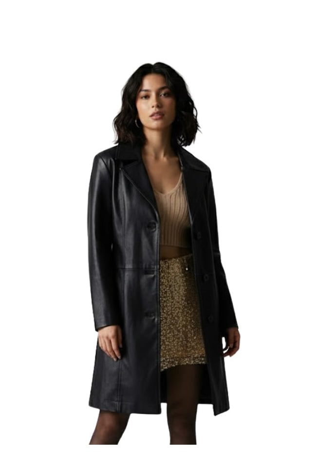 Woman wearing a black leather coat over a beige top and leopard print skirt on a white background