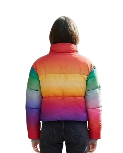 Person wearing a rainbow-colored puffer jacket on a white background