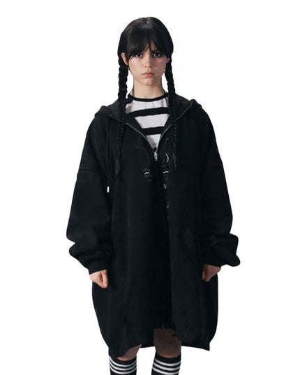 Person wearing a black hooded coat on a white background