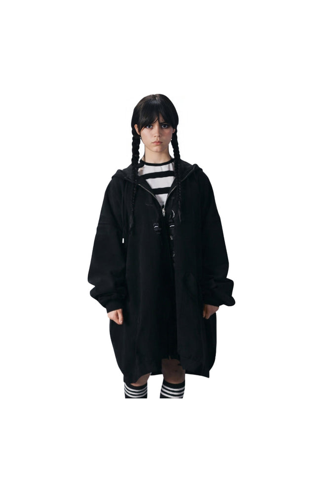 Person wearing a black hooded coat on a white background