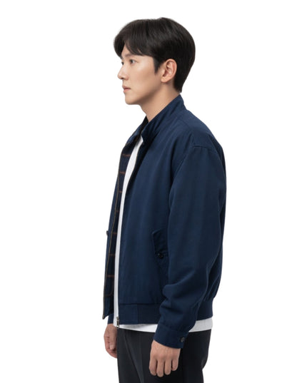 Person wearing a navy blue jacket on a white background