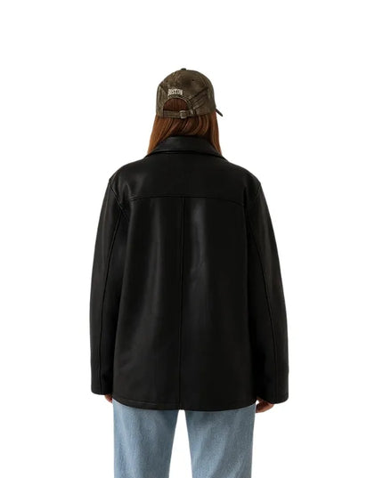 Women’s 90s style vintage oversized black leather long jacket with straight fit silhouette.