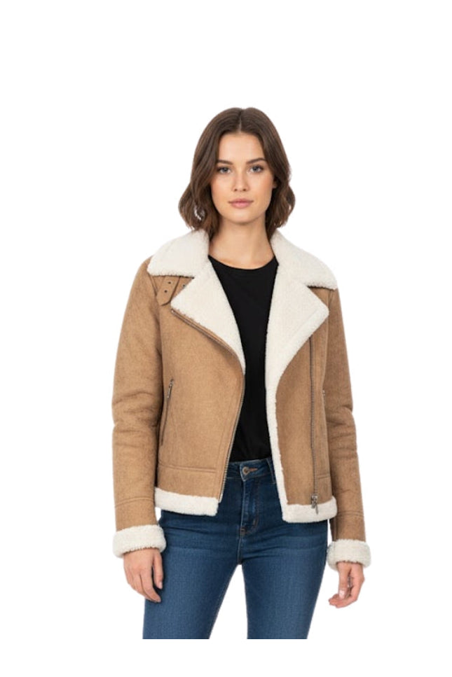 Woman wearing a brown shearling jacket with white lining on a white background