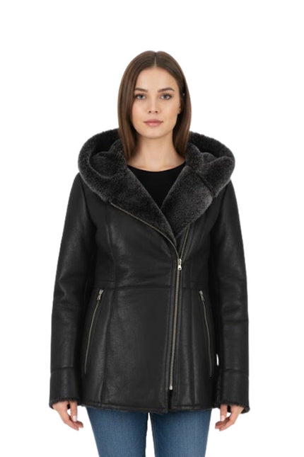 Woman wearing a black leather jacket with fur collar on a white background