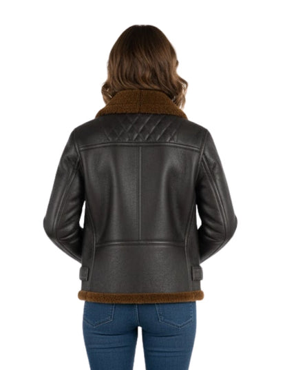 Person wearing a black leather jacket with brown shearling lining on a white background