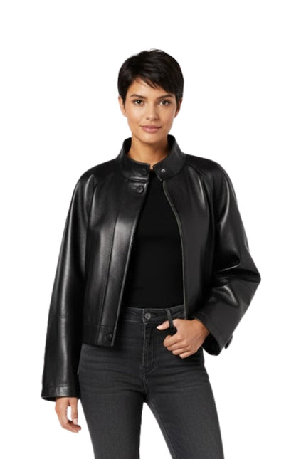 Woman wearing a black leather jacket and jeans on a white background