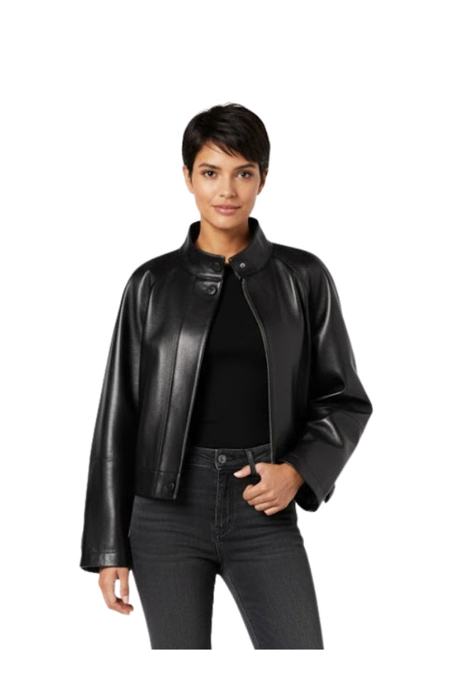 Woman wearing a black leather jacket and jeans on a white background
