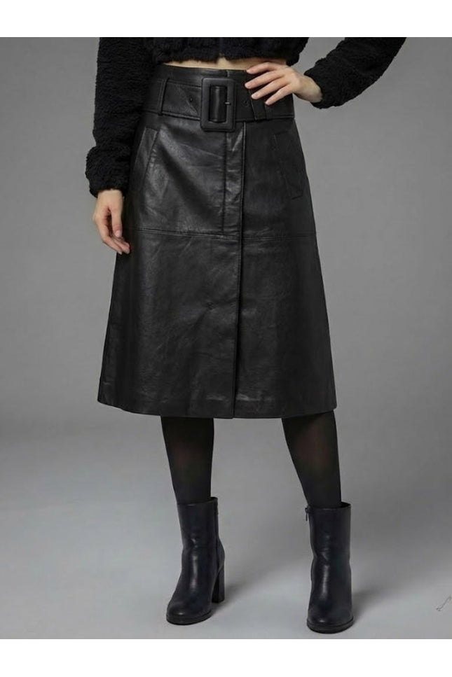 Person wearing a black leather skirt with a belt on a gray background