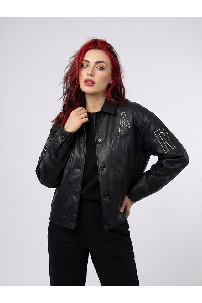 Woman wearing a black leather jacket with 'A' and 'R' patches on a white background